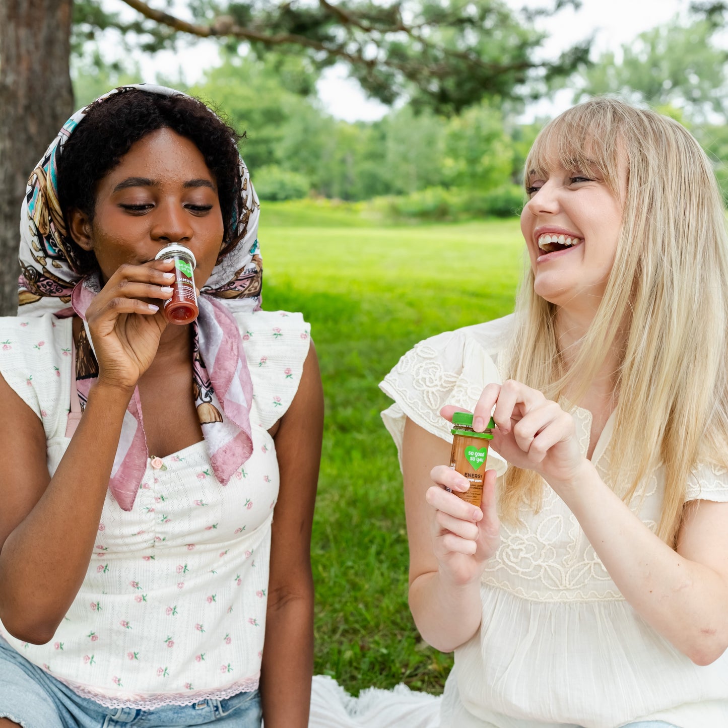 Two girls enjoying So Good So You organic juice wellness shots