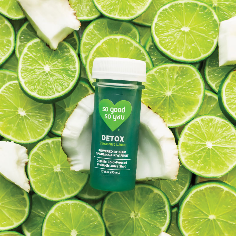 Detox Coconut Lime Juice Shot on top of raw coconut and lime
