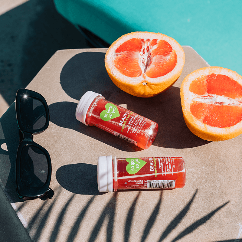 
                      
                        Beauty Grapefruit Juice Shot next to a pool with a grapefruit and sunglasses nearby
                      
                    