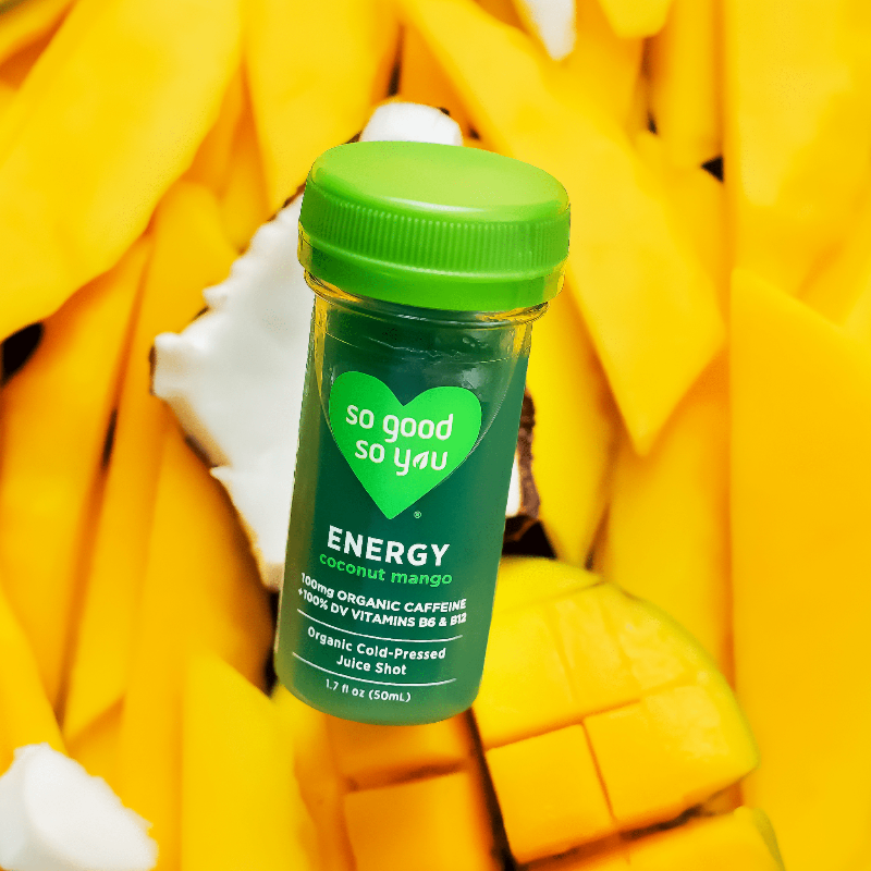 Energy Coconut Mango Juice Shot on top of raw mango and coconut