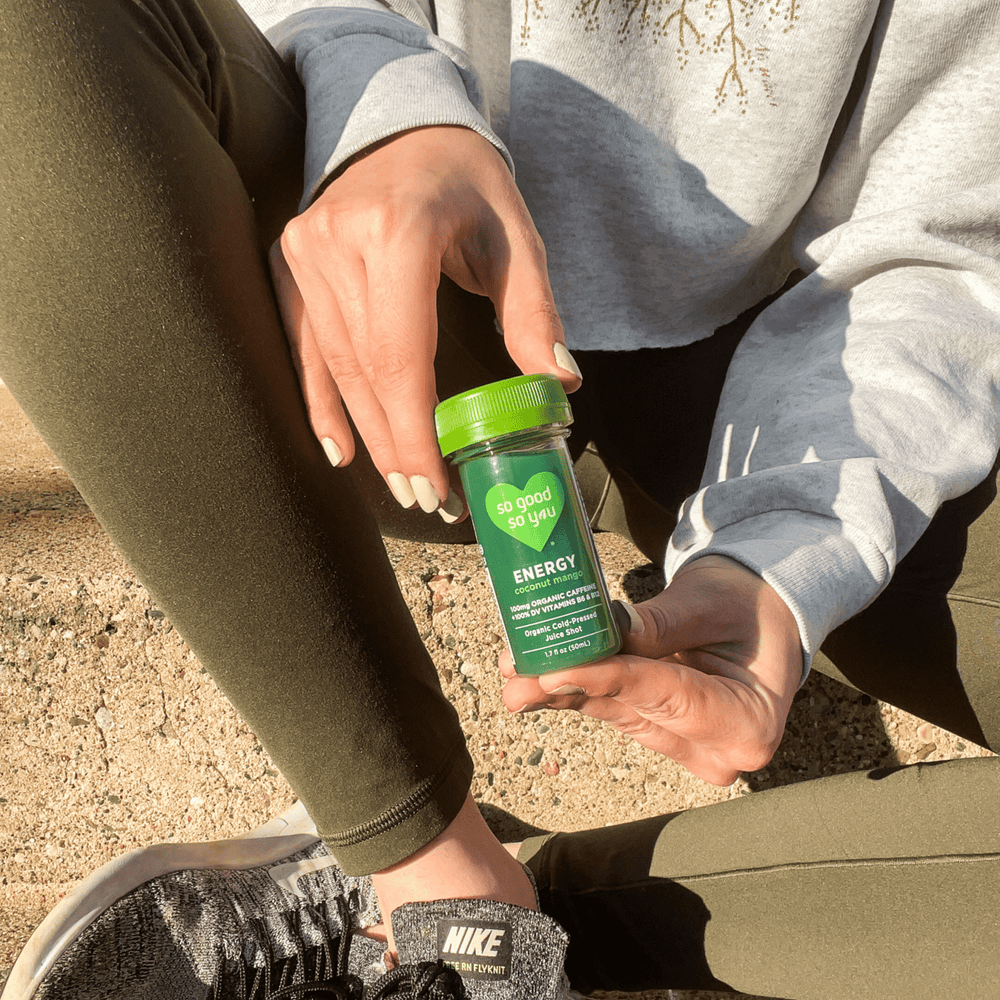 
                      
                        Energy Coconut Mango Juice Shot being held during a workout
                      
                    