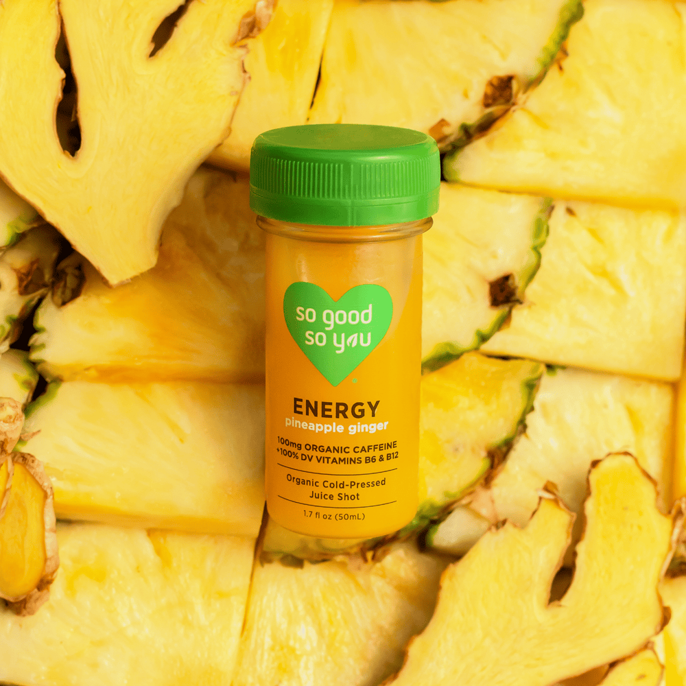 Energy Pineapple Ginger Juice Shot on top of raw pineapple